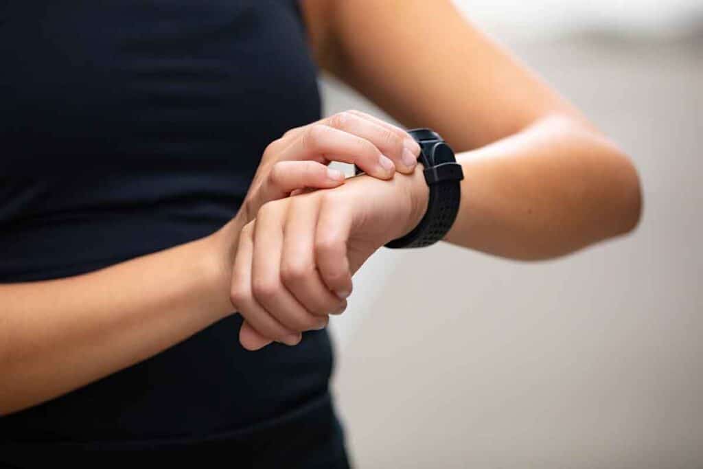 A photo of a person checking a fitness app on their watch.