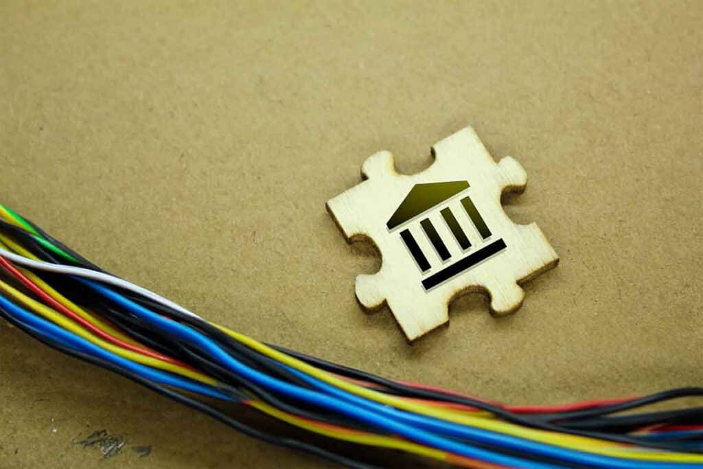 Generative AI photo illustration showing digital banking with wires, a puzzle piece with a bank icon.